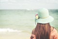 happy young woman wear straw hat - stand on the beach in summer