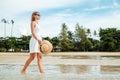 Happy young woman wearing beautiful white dress walking on the beach Royalty Free Stock Photo