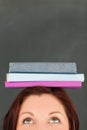 Happy young woman wearing books on her head Royalty Free Stock Photo