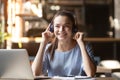 Happy young woman wearing headphones listening to music in cafe Royalty Free Stock Photo