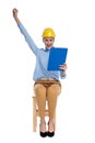 Happy young woman wearing safety helmet and holding clipboard Royalty Free Stock Photo