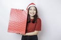 A happy young woman is wearing Santa Claus` hat and holding Christmas presents Royalty Free Stock Photo