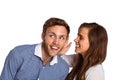 Happy young woman whispering secret into friends ear Royalty Free Stock Photo