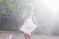 Happy young woman white dress dancing on stone road Royalty Free Stock Photo