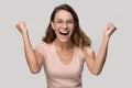 Happy young woman winner celebrating victory win looking at camera Royalty Free Stock Photo