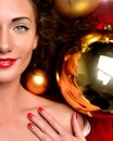 happy young woman in winter christmas decoration ornament smiling with gold balls Royalty Free Stock Photo