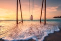 Happy young woman on wooden swing in water, sea with waves Royalty Free Stock Photo