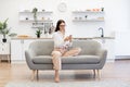 Woman working remotely from home, typing on modern wireless cell phone. Royalty Free Stock Photo