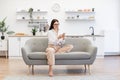 Woman working remotely from home, typing on modern wireless cell phone. Royalty Free Stock Photo