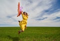 Happy young woman jumping for joy on a wheat field Royalty Free Stock Photo