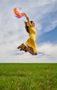 Happy young woman jumping for joy on a wheat field Royalty Free Stock Photo