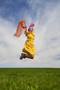 Happy young woman jumping for joy on a wheat field Royalty Free Stock Photo