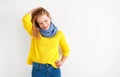 Happy young woman in yellow sweater on white background