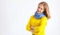 Ppy young woman in yellow sweater on white background