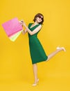 Happy young womanl holding shopping bags  and  dancing Royalty Free Stock Photo