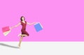 Happy young womanl holding shopping bags  and running Royalty Free Stock Photo