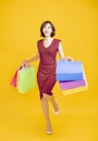 Happy young womanl holding shopping bags and running Royalty Free Stock Photo