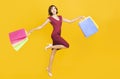Happy young womanl holding shopping bags  and running Royalty Free Stock Photo