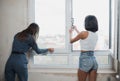 Happy young women doing repair in their new house. Royalty Free Stock Photo