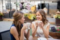 Happy young women drinking coffee at outdoor cafe Royalty Free Stock Photo