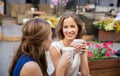 Happy young women drinking coffee at outdoor cafe Royalty Free Stock Photo