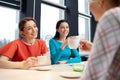 Happy young women drinking tea or coffee at cafe Royalty Free Stock Photo