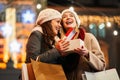 Happy women friends exchanging christmas present. Happiness people friend shopping xmas concept