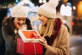 Happy women friends exchanging christmas present. Happiness people friend shopping xmas concept