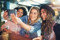 Happy young women friends posing for a selfie