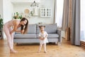 Happy young woman and her small daughter as a microphones singing songs having fun