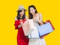 Happy young women looking into shopping bags Royalty Free Stock Photo