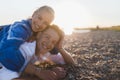 Happy young woman lying on her boyfriends back, looking at camera, having fun together. Royalty Free Stock Photo