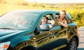 Happy young women and man driver enjoying a summerÃ¢â¬â¢s road trip together. Road trip Hangouts