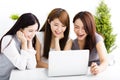 happy young women watching laptop in living room