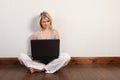 Happy young girl on floor surfing internet at home Royalty Free Stock Photo