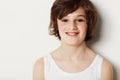 Happy youngster. Preteen boy wearing a vest while isolated on white with a smile.