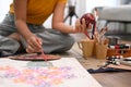 Happy young woman painting picture with watercolor at cozy home. Art, creative hobby and leisure activity concept Royalty Free Stock Photo