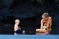 Happymother, dirty child having fun on black sand beach Royalty Free Stock Photo