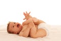 Hapy baby boy in playing on bed isolated over white Royalty Free Stock Photo