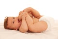 Hapy baby boy in playing on bed isolated over white