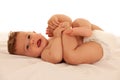 Hapy baby boy in playing on bed isolated over white Royalty Free Stock Photo