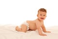 Hapy baby boy in playing on bed isolated over white Royalty Free Stock Photo