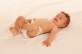 Hapy baby boy in playing on bed isolated over white Royalty Free Stock Photo