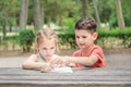 Hapy kids learn in a park. Brother and sister together do the j