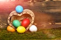 Easter colorful eggs in wooden heart box Royalty Free Stock Photo