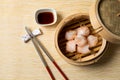 HAR GOW in bamboo steamer with sauces and chopsticks. Chinese Traditional cuisine concept. Dumplings Dim Sum in bamboo steamer Royalty Free Stock Photo