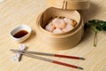 HAR GOW in bamboo steamer with sauces and chopsticks. Chinese Traditional cuisine concept. Dumplings Dim Sum in bamboo steamer Royalty Free Stock Photo