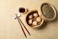 HAR GOW in bamboo steamer with sauces and chopsticks. Chinese Traditional cuisine concept. Dumplings Dim Sum in bamboo steamer Royalty Free Stock Photo