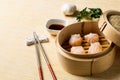 HAR GOW in bamboo steamer with sauces and chopsticks. Chinese Traditional cuisine concept. Dumplings Dim Sum in bamboo steamer Royalty Free Stock Photo