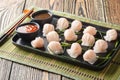 Har gow is a traditional Cantonese dumpling stuffed with shrimp closeup on the plate. Horizontal